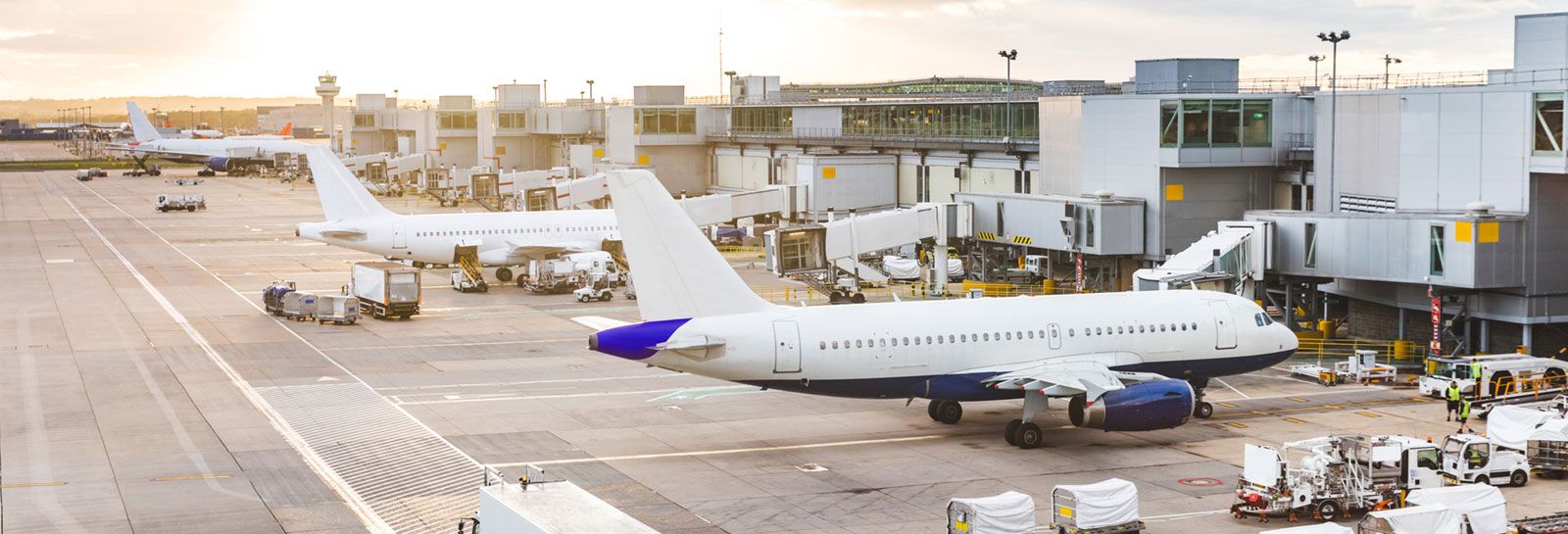 planes and service vehicles at airport banner image